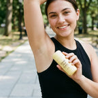 Vanilla and pistachio balm held beside underarm